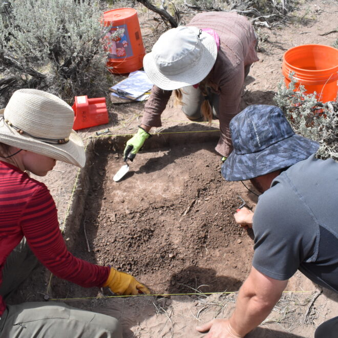Volunteers conducting excavation near a suspected feature.